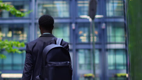 Young-Businessman-Wearing-Backpack-Walking-To-Work-In-Offices-In-The-Financial-District-Of-The-City-Of-London-UK