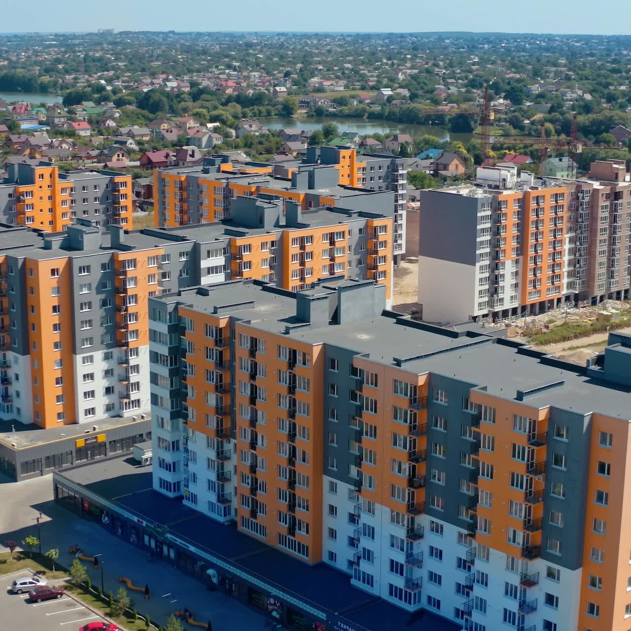 Residential complex with multi-storey buildings. Modern area with new skyscrapers in the outskirts of a city. Colorful architecture of urban housing. Aerial view