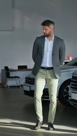 man in a business suit in a car dealership