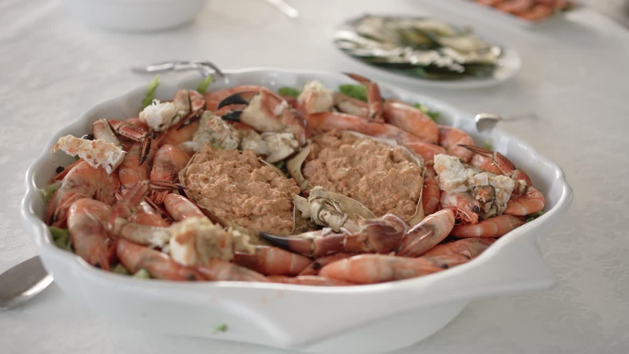 Portuguese seafood platter, shrimp and stuffed crab arranged in a white bowl for a meal