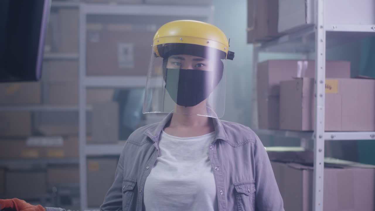 Woman in Protective Gear in a Warehouse
