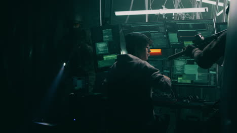 military arresting hacker in dark room