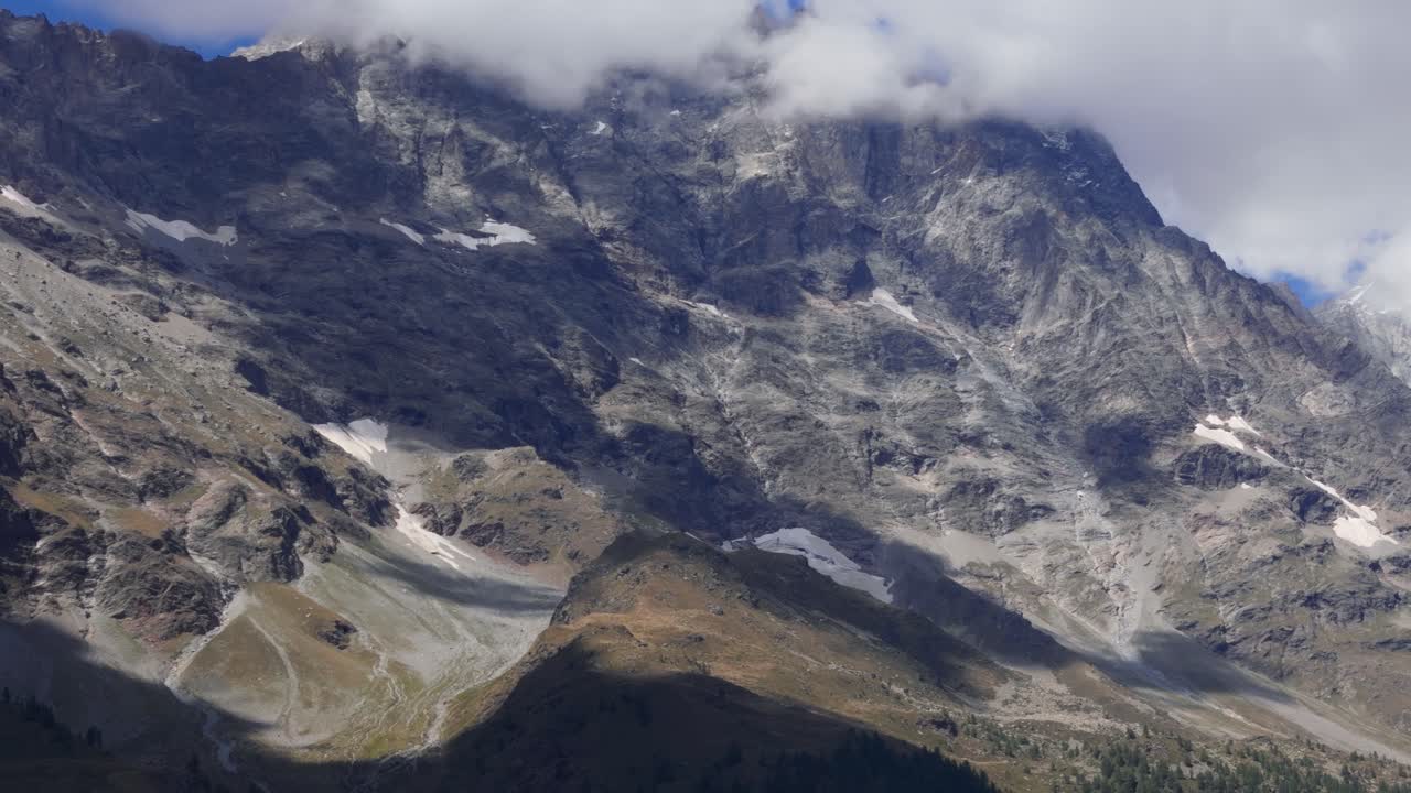 Aerial view of clouds reaching the top of a mountain in the Aosta Valley region of north western Italy Italia creating a dramatic scenic mood