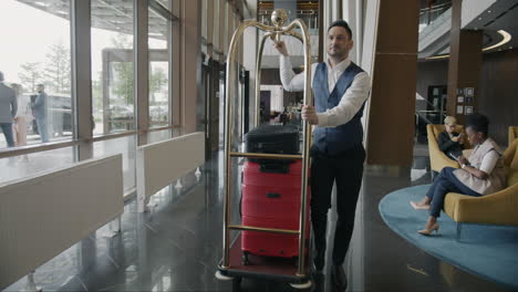 hotel bellhop with luggage cart