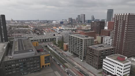 forward droneshot of the hague railway station and city centre, train leaving