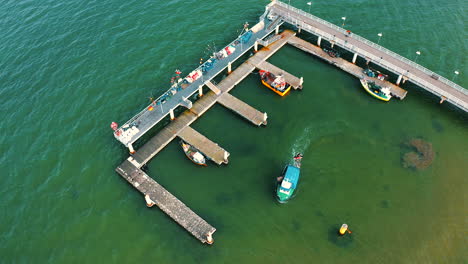 Top-view-of-pier-with-fishing-boats-in-Mechelinki,-Poland