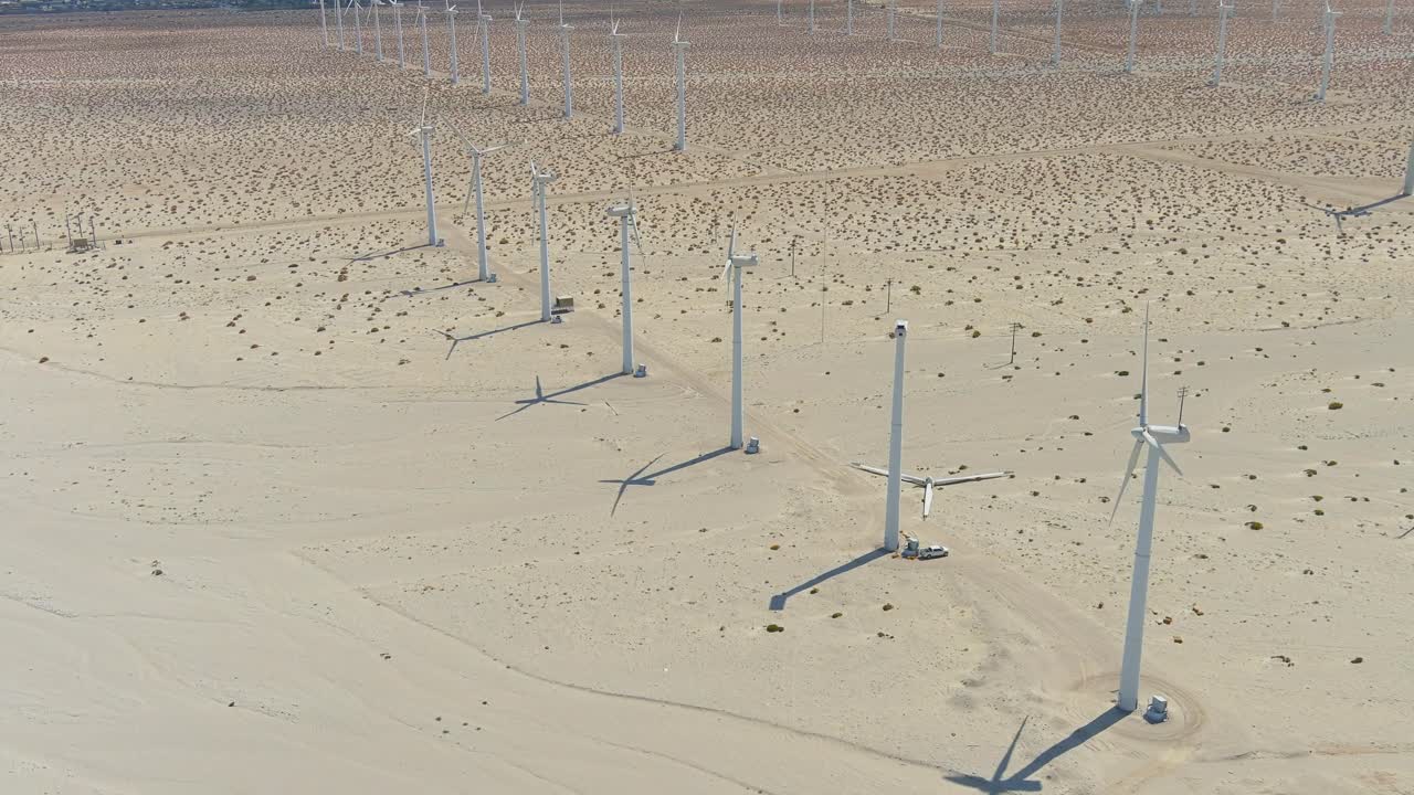 toma aérea en órbita del parque eólico en el desierto de palm springs | iluminación de la tarde