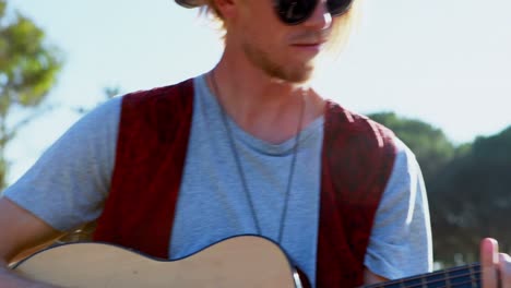 man playing guitar at festival 4k