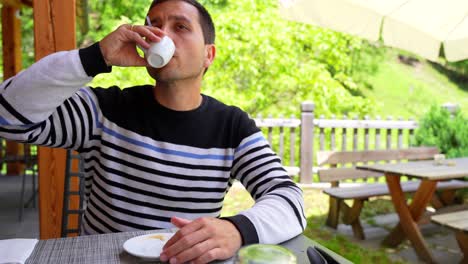 Close-up-of-man-in-coffee-shop-drinking-an-Italian-espresso,-Sottoguda