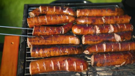 grilling tasty sausages on barbecue grill