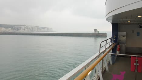 white cliffs of dover seen in distance from ferry deck cruising across english channel in the uk
