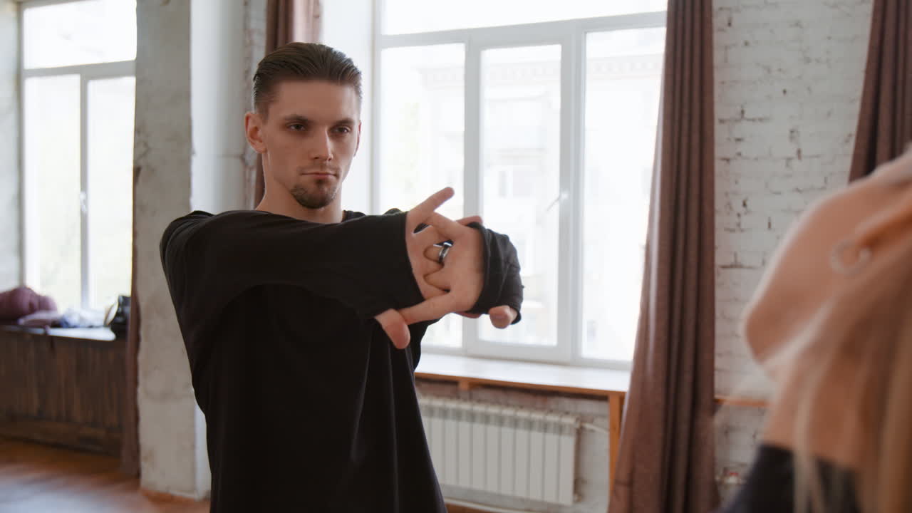 Man Stretching and Warming Up in a Dance Studio