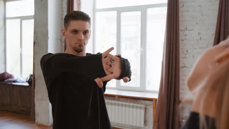 man stretching and warming up in a dance studio