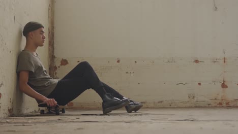 fashionable young man in an abandoned warehouse