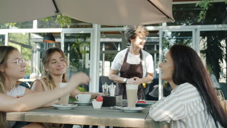 friends enjoying coffee at an outdoor cafe