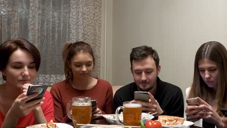 friends enjoying dinner and social media