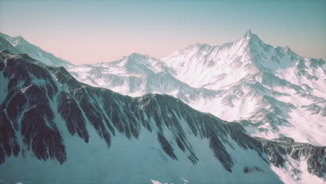 aerial view from airplane of blue snow covered canadian mountain landscape