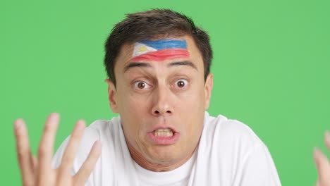 man with philippine national flag upset with a referee