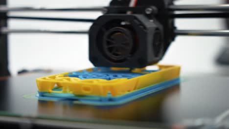 watch as a multicolored phone case takes shape in a workshop. the innovative process showcases precise layering and vibrant materials being carefully applied in real time.