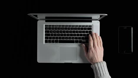 a man working on a laptop online from his home