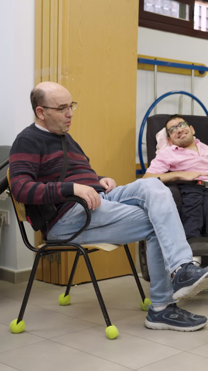 Two men conversing indoors