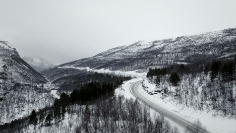 aerial along highway e8 through white snow covered winter landscape, norway