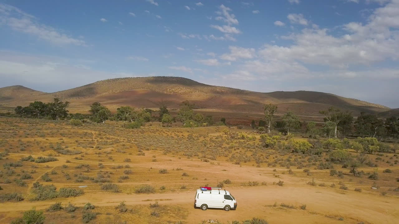 South Australia outback landscape, aerial pull back over campervan