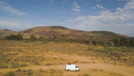 south australia outback landscape, aerial pull back over campervan