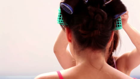 Girl-fixing-her-friends-hair-rollers