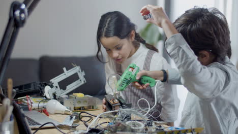 two smart kids doing school project at home