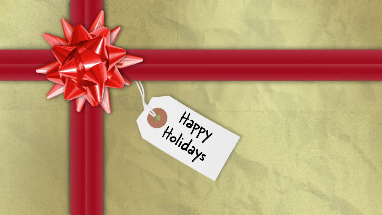 Animation of happy holidays text on tag over christmas present with red ribbon