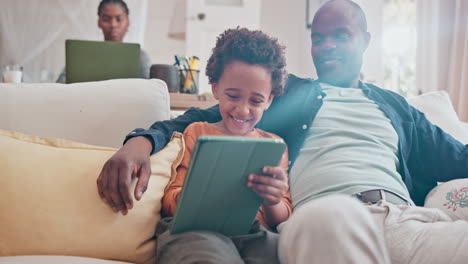 father and daughter enjoying tablet time at home