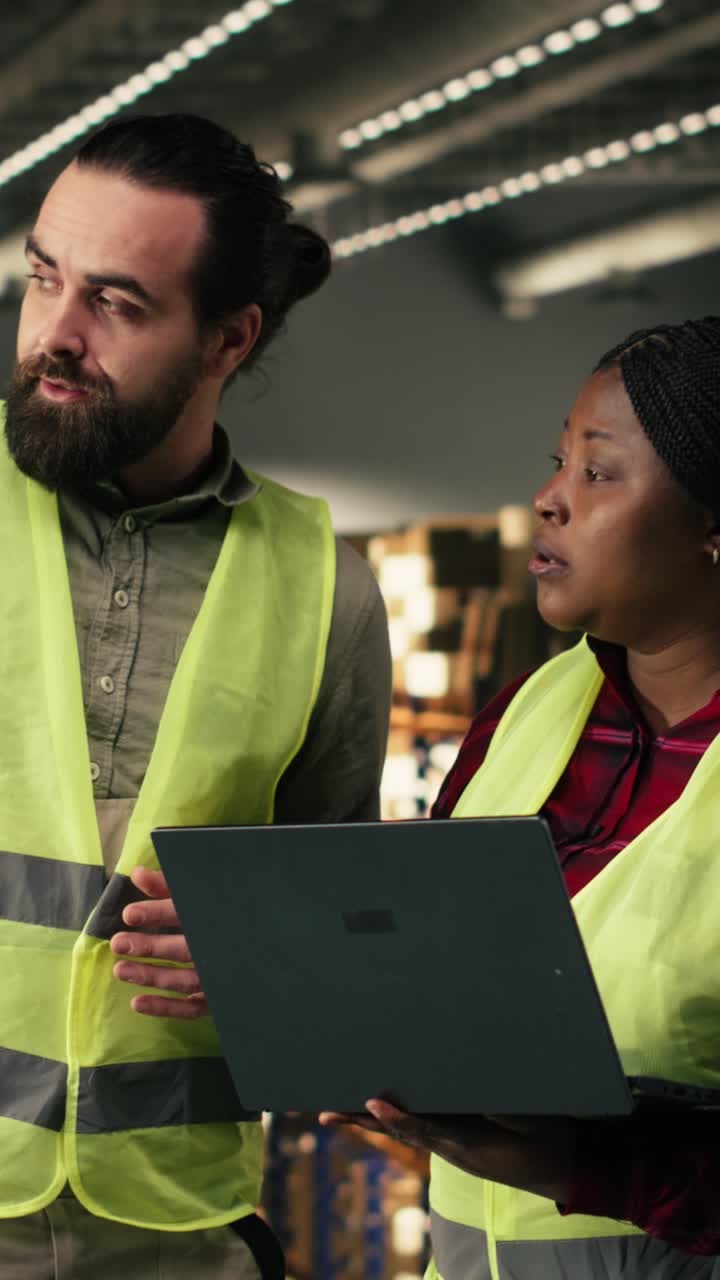 Vertical Video Diverse team of employees, laptop tracking software, logistics center