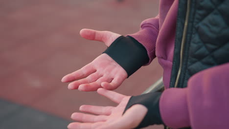 hand view of workout junkie rubbing palms together after intense exercise, preparing for next set, athlete wearing workout gear, ready for the next training move, fitness, exercise motivation
