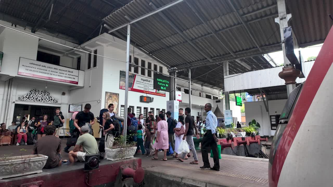 Kandy train station with backpackers and travelers waiting on the platform, capturing the essence of cultural journeys and exploration in Sri Lanka.