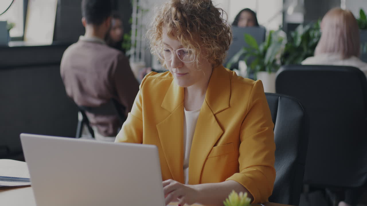 Woman working on laptop in modern office