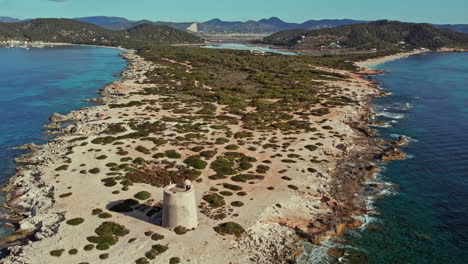 Aerial-Revealed-Punta-de-Sa-Torre-With-Torre-de-Ses-Portes-And-Ses-Salines-Beach-In-Ibiza,-Balearic-Islands,-Spain