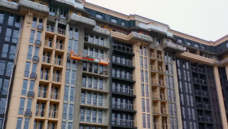 building of new tower architecture. modern multi storey building under construction. front view of a high-rise building. workers build the tall house.