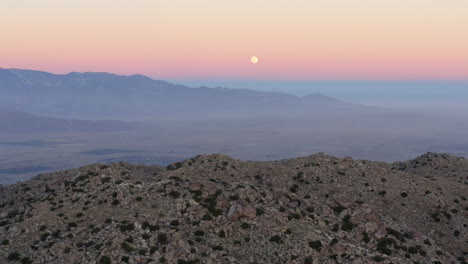 sunset over stone hill, vast desert, california state park, freedom scene, aerial pullback