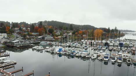 Aerial-dolly-in-shot-of-boats-in-the-marina-of-a-coastal-town-in-Washington,-USA