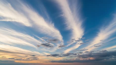 dramatic wispy clouds in a blue sky at sunset