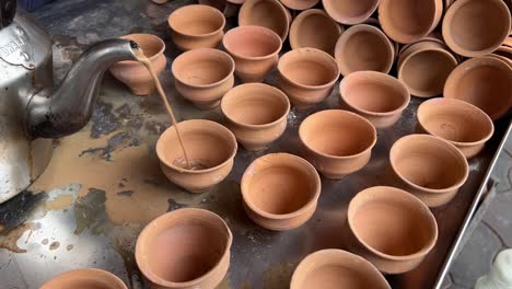 hot tea getting served in a kulhad in a road side stall in india