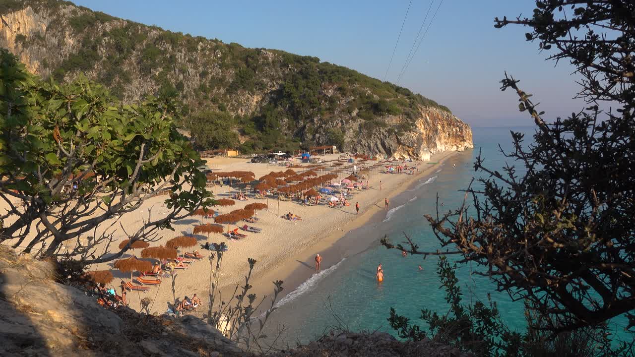 Looking down at beautiful hidden beach in cove at sunset