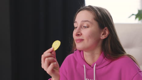 Mujer-Joven-Feliz-Sentada-En-El-Escritorio-Y-Comiendo-Deliciosas-Papas-Fritas-1