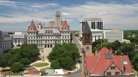 New-York-State-Capitol-building-in-Albany,-New-York-with-church-in-view-with-drone-video-moving-sideways