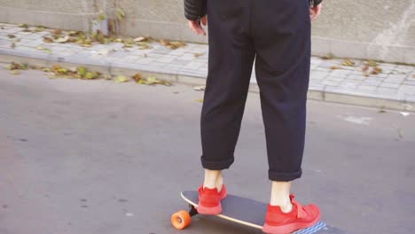 young man in red sneakers skating in the street