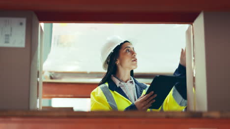 Engineering,-tablet-and-woman-in-a-warehouse-doing