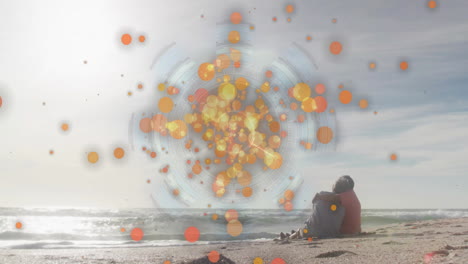 person sitting on beach with colorful circular animation over ocean waves