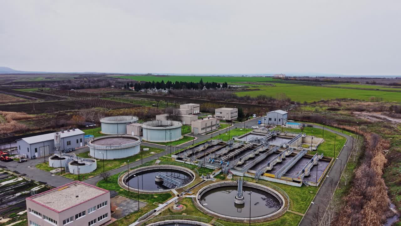 Wastewater treatment plant located in a rural area with tanks and buildings