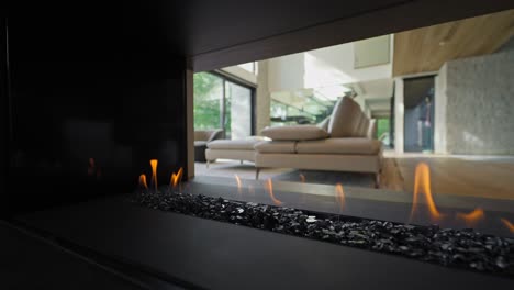 3-sided modern gas fireplace open on three sides in luxury house interior - side dolly in slow motion